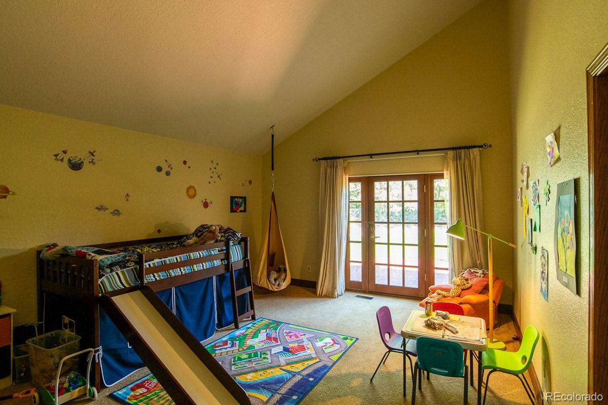 7181 Four Rivers Road Boulder, CO 80301 - Photo 21 of 35 a bedroom with furniture and a window