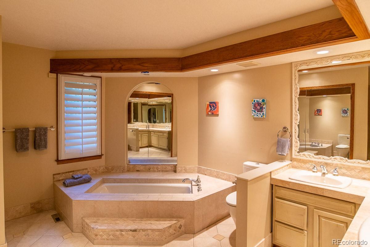 7181 Four Rivers Road Boulder, CO 80301 - Photo 22 of 35 a bathroom with a tub sink and mirror