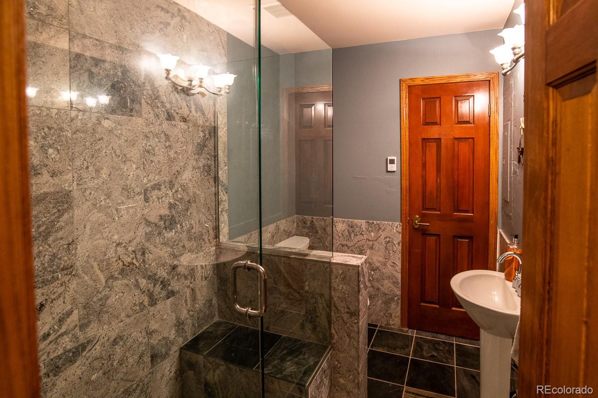 7181 Four Rivers Road Boulder, CO 80301 - Photo 25 of 35 a bathroom with a granite countertop shower