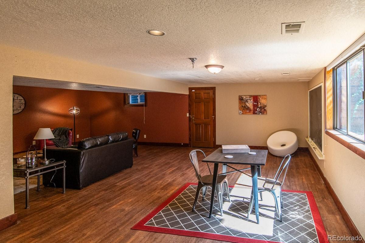 7181 Four Rivers Road Boulder, CO 80301 - Photo 29 of 35 a living room with furniture and wooden floor