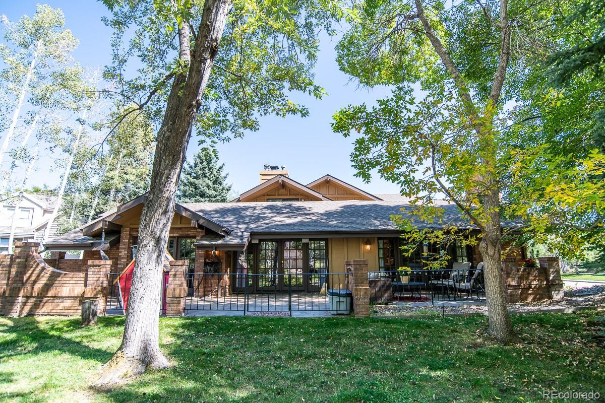 7181 Four Rivers Road Boulder, CO 80301 - Photo 33 of 35 a patio with table and chairs and a large tree