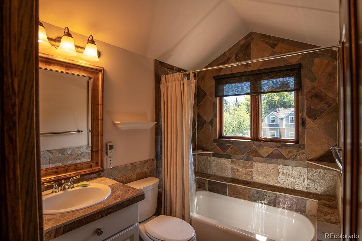 7181 Four Rivers Road Boulder, CO 80301 - Photo 34 of 35 a bathroom with a granite countertop tub sink and mirror