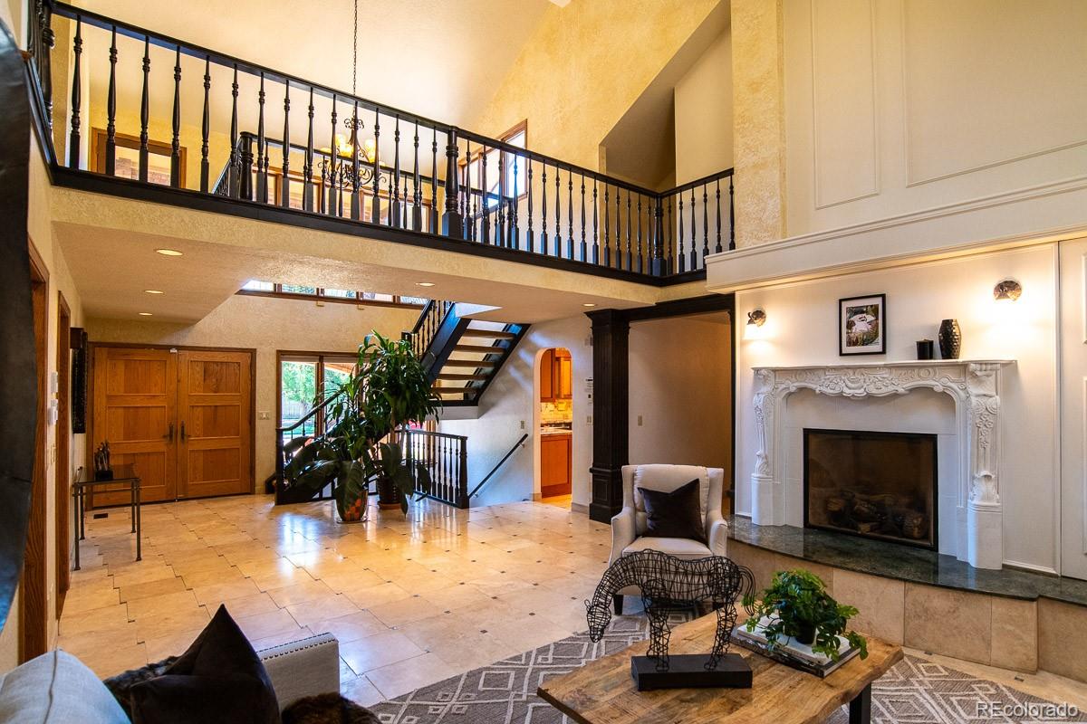 7181 Four Rivers Road Boulder, CO 80301 - Photo 4 of 35 a living room with furniture a fireplace and a table