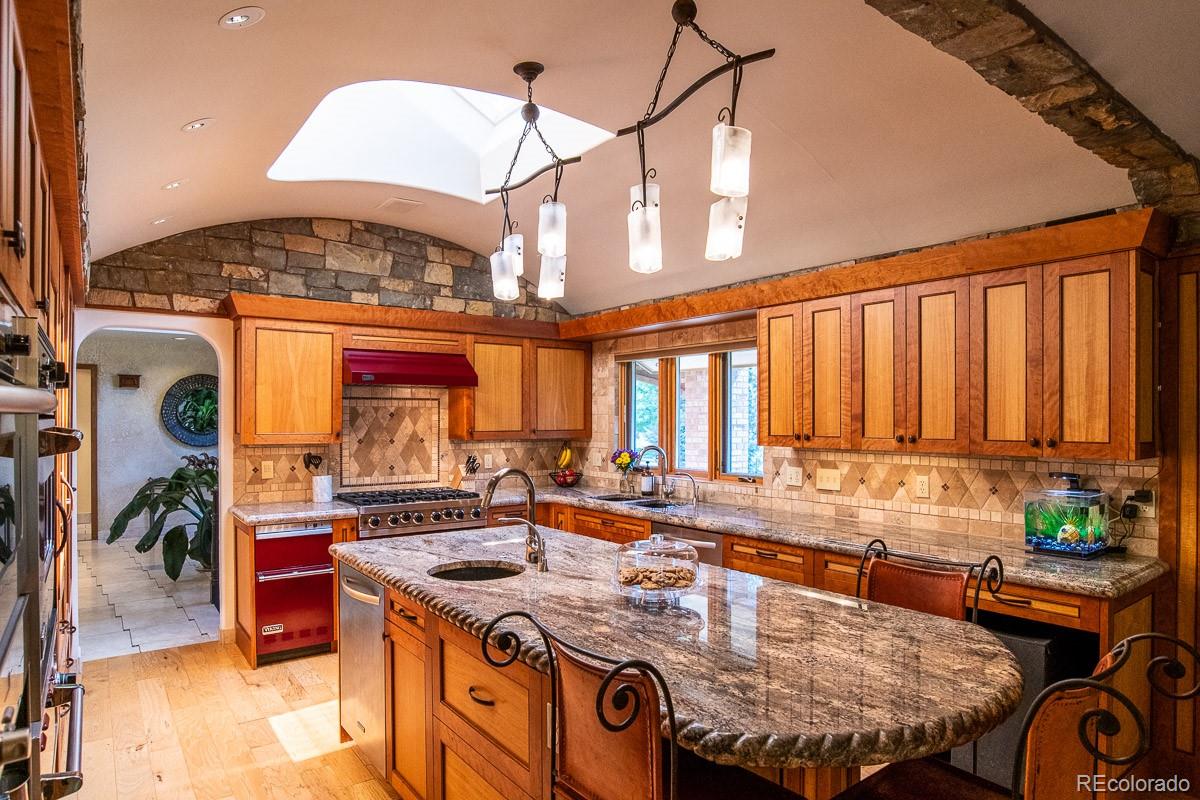 7181 Four Rivers Road Boulder, CO 80301 - Photo 7 of 35 a kitchen with a stove and a view of living room