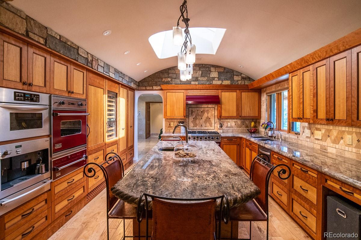 7181 Four Rivers Road Boulder, CO 80301 - Photo 8 of 35 a large kitchen with stainless steel appliances granite countertop a stove and refrigerator