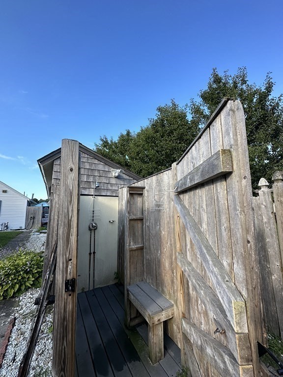 174 Captain Chase Road, Unit 9 Dennis, MA 02639 - Photo 20 of 23 a view of a wooden door with a house