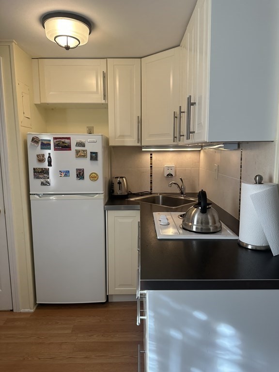 174 Captain Chase Road, Unit 9 Dennis, MA 02639 - Photo 5 of 23 a kitchen with stainless steel appliances a sink stove and cabinets