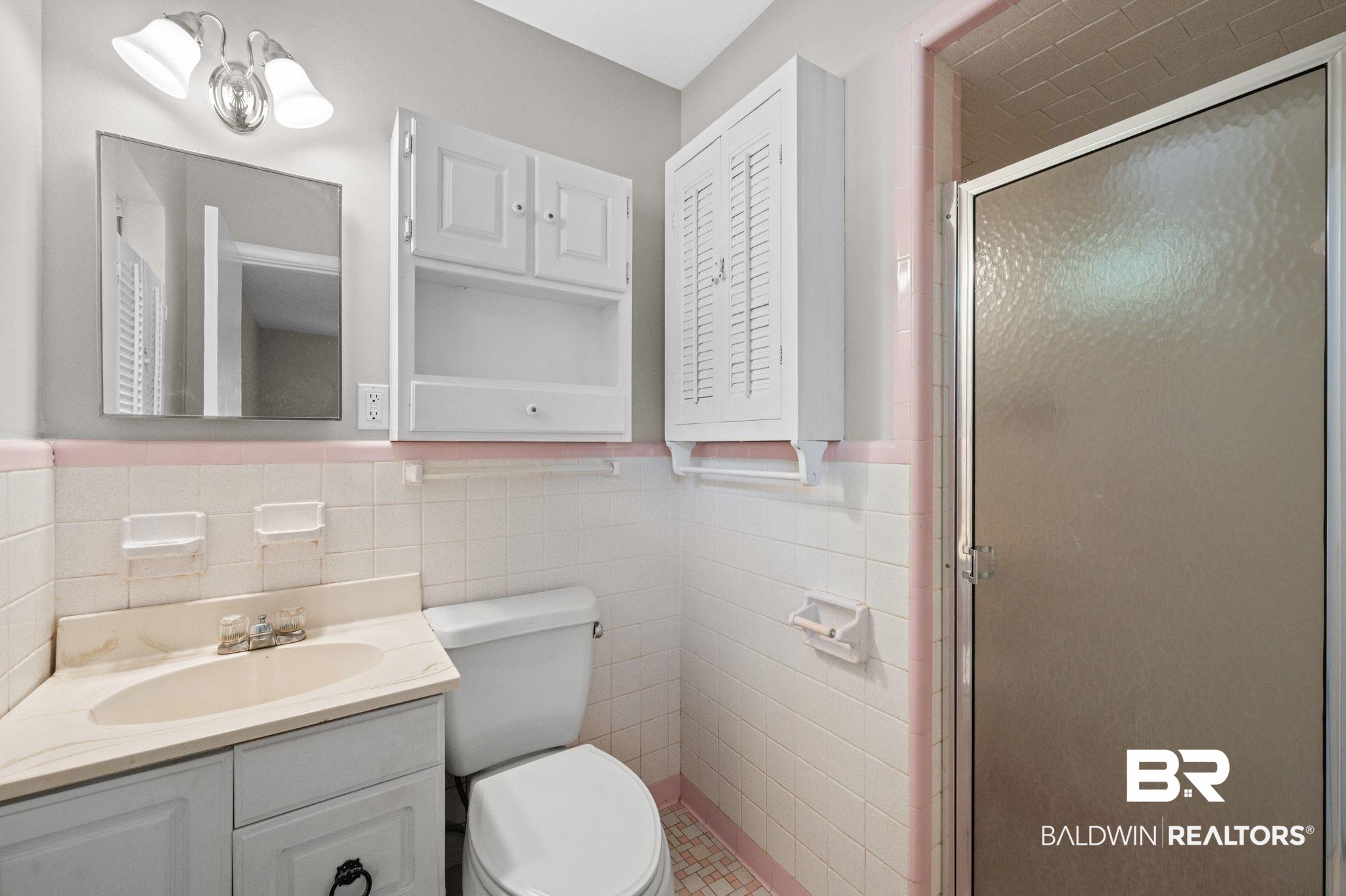 909 Caroline Avenue Daphne, AL 36526 - Photo 35 of 46 Bathroom with vanity, a shower with shower door, tile walls, and toilet