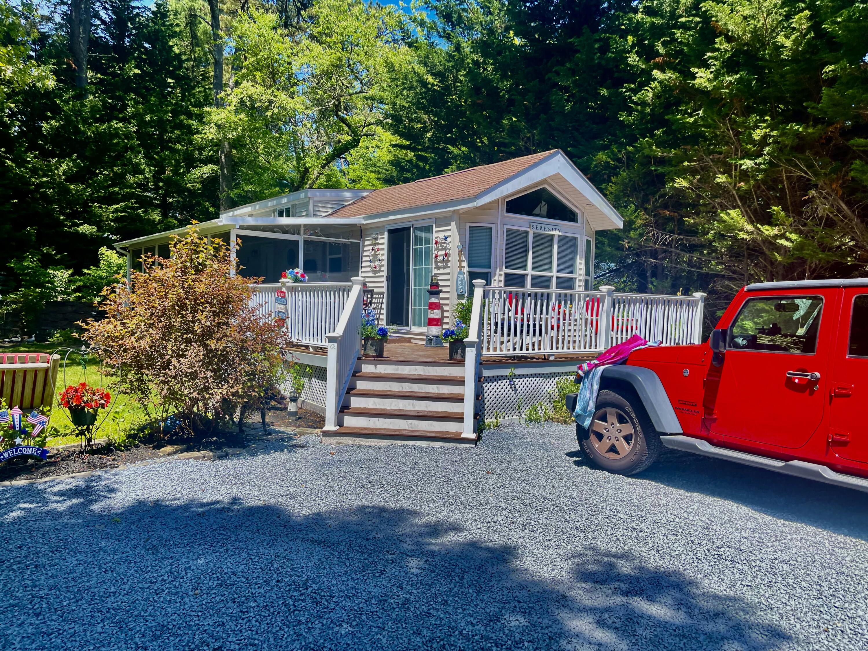 a front view of house with deck and yard