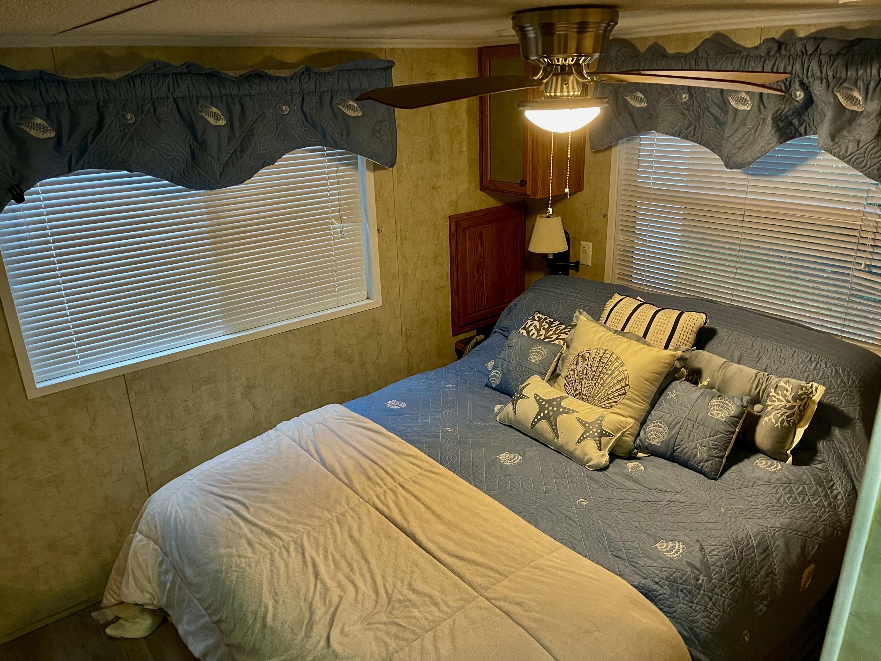 185 Cotuit Road, Unit C5 ASPEN Sandwich, MA 02563 - Photo 13 of 17 a bedroom with a bed and a chandelier