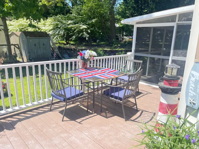 a view of a chairs and table in the roof deck