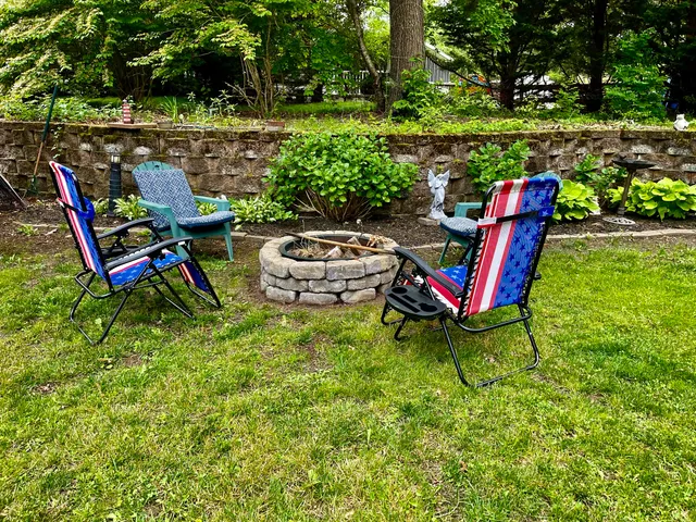 a backyard of a house with table and chairs