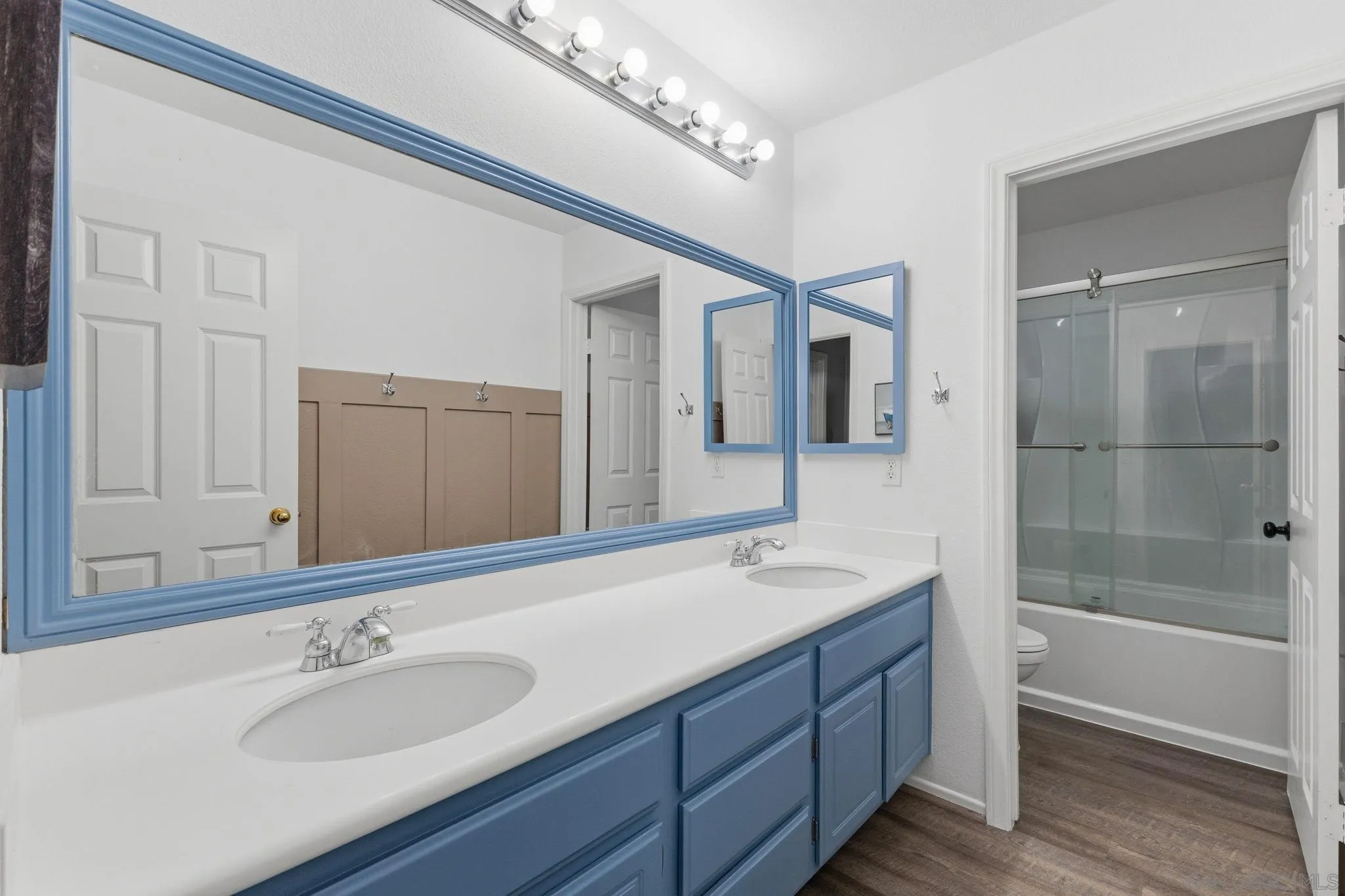 31342 Euclid Loop Winchester, CA 92596 - Photo 34 of 50 a bathroom with a tub a double vanity sink and a mirror