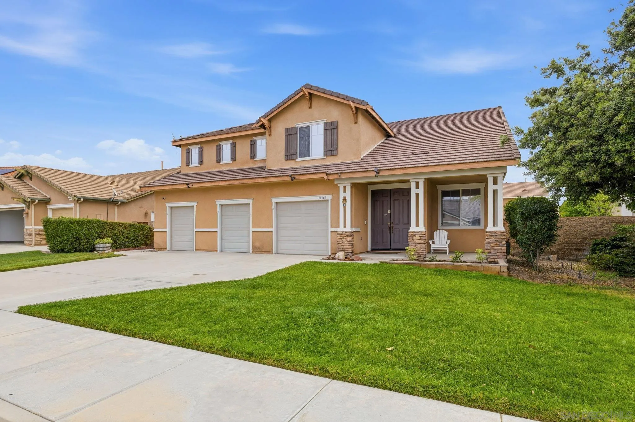 31342 Euclid Loop Winchester, CA 92596 - Photo 6 of 50 a front view of a house with a garden and yard