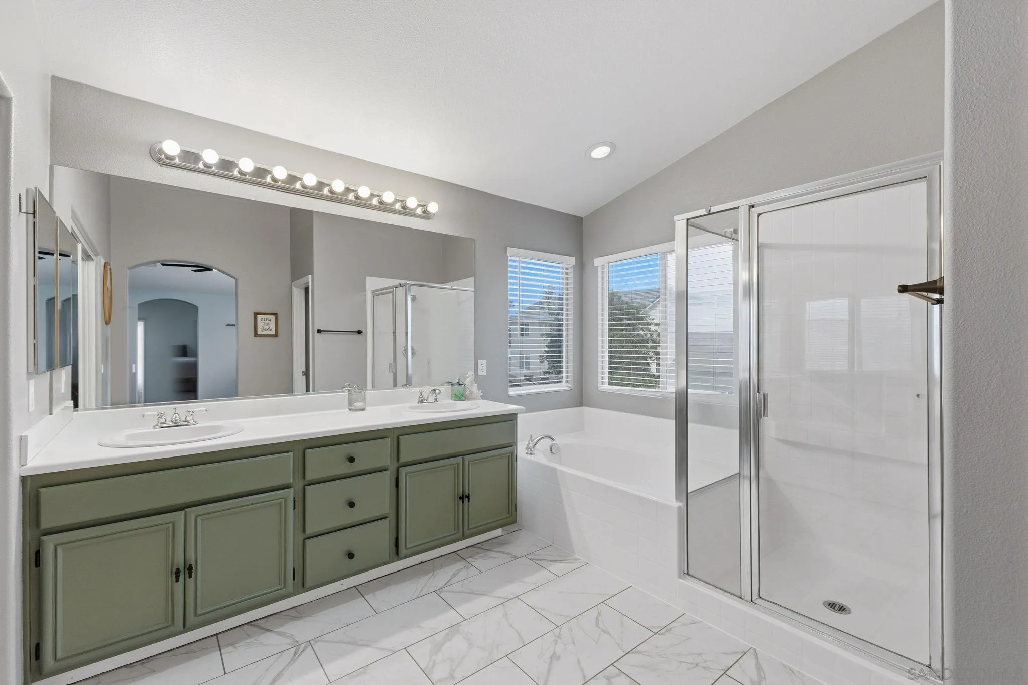 31342 Euclid Loop Winchester, CA 92596 - Photo 8 of 50 a spacious bathroom with a double vanity sink a mirror and a bathtub