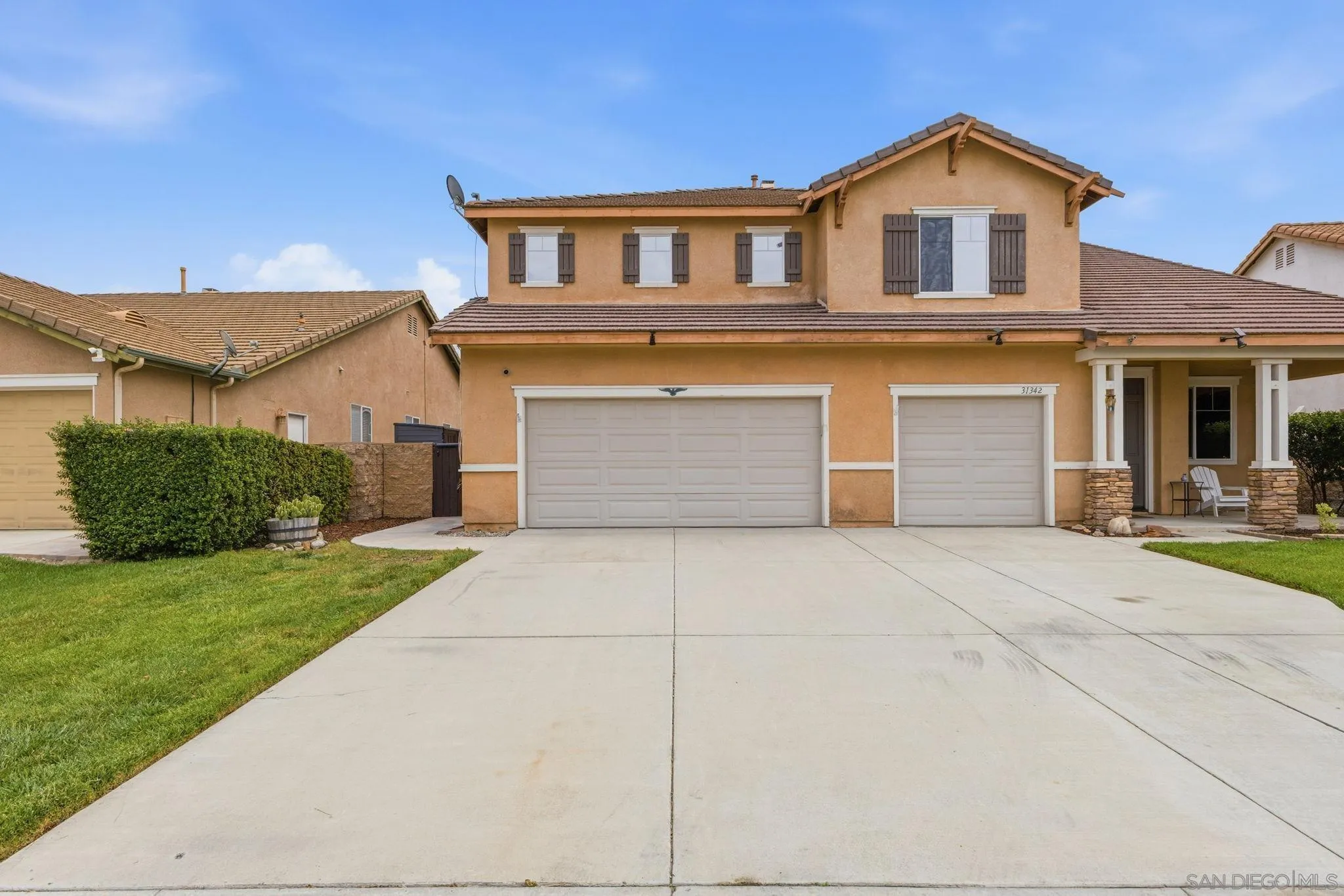 31342 Euclid Loop Winchester, CA 92596 - Photo 9 of 50 a front view of a house with a yard and garage