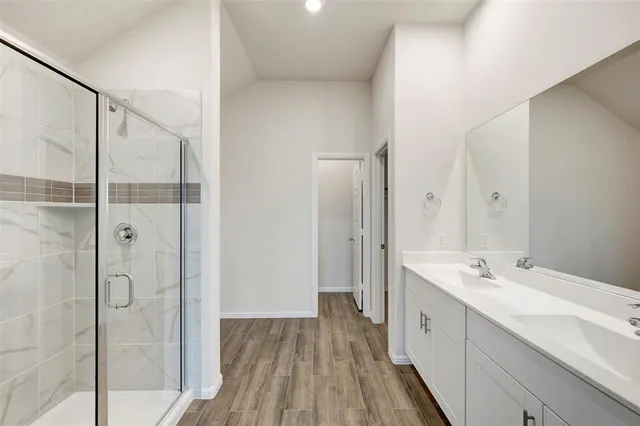 a spacious bathroom with a shower and a sink