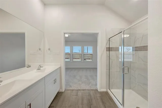 a spacious bathroom with a shower sink and mirror