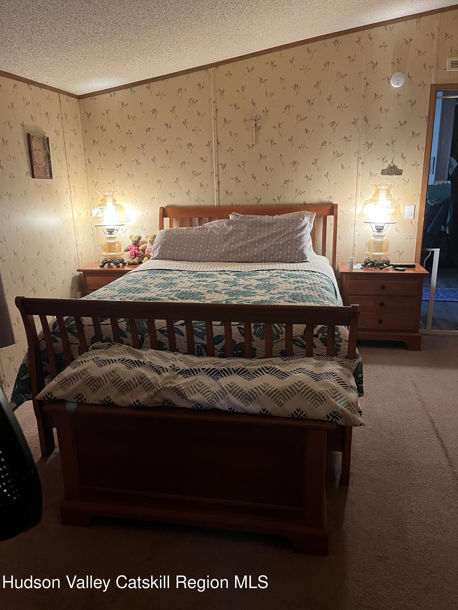 552 Travis Hill Road Rensselaerville, NY 12469 - Photo 8 of 11 a bedroom with a bed and wooden floor