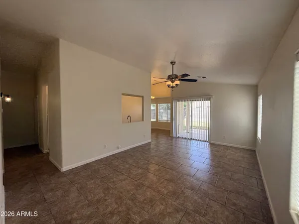 an empty room with windows and cabinet