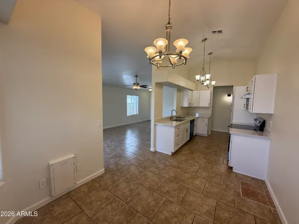 a view of a kitchen with a sink stainless steel appliances and cabinets