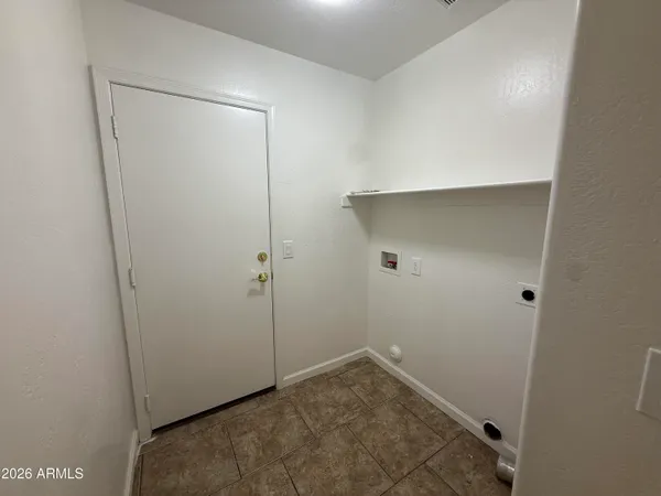 a spacious bathroom with a toilet sink and mirror