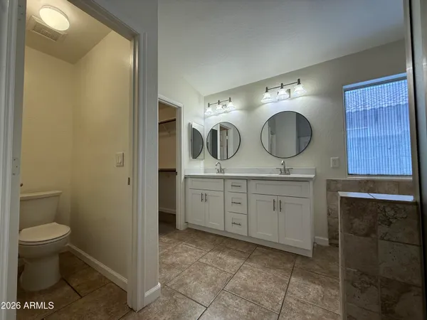 a bathroom with a double vanity sink and a mirror