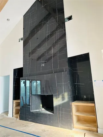 an aerial view of residential house with outdoor space and trees all around