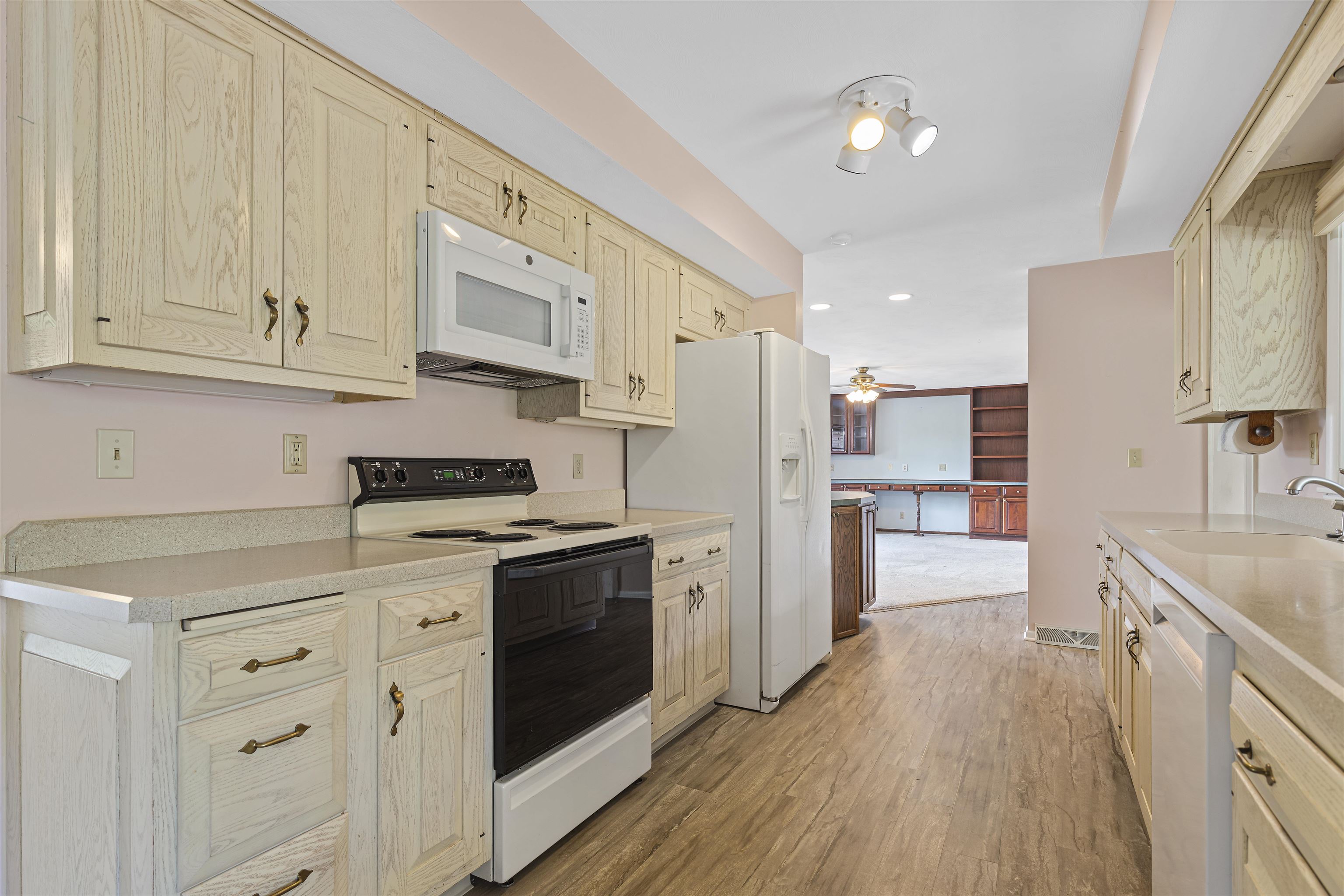 814 Roxbury Road Rockford, IL 61107 - Photo 8 of 36 a kitchen with stainless steel appliances granite countertop a refrigerator a stove and white cabinets with wooden floors