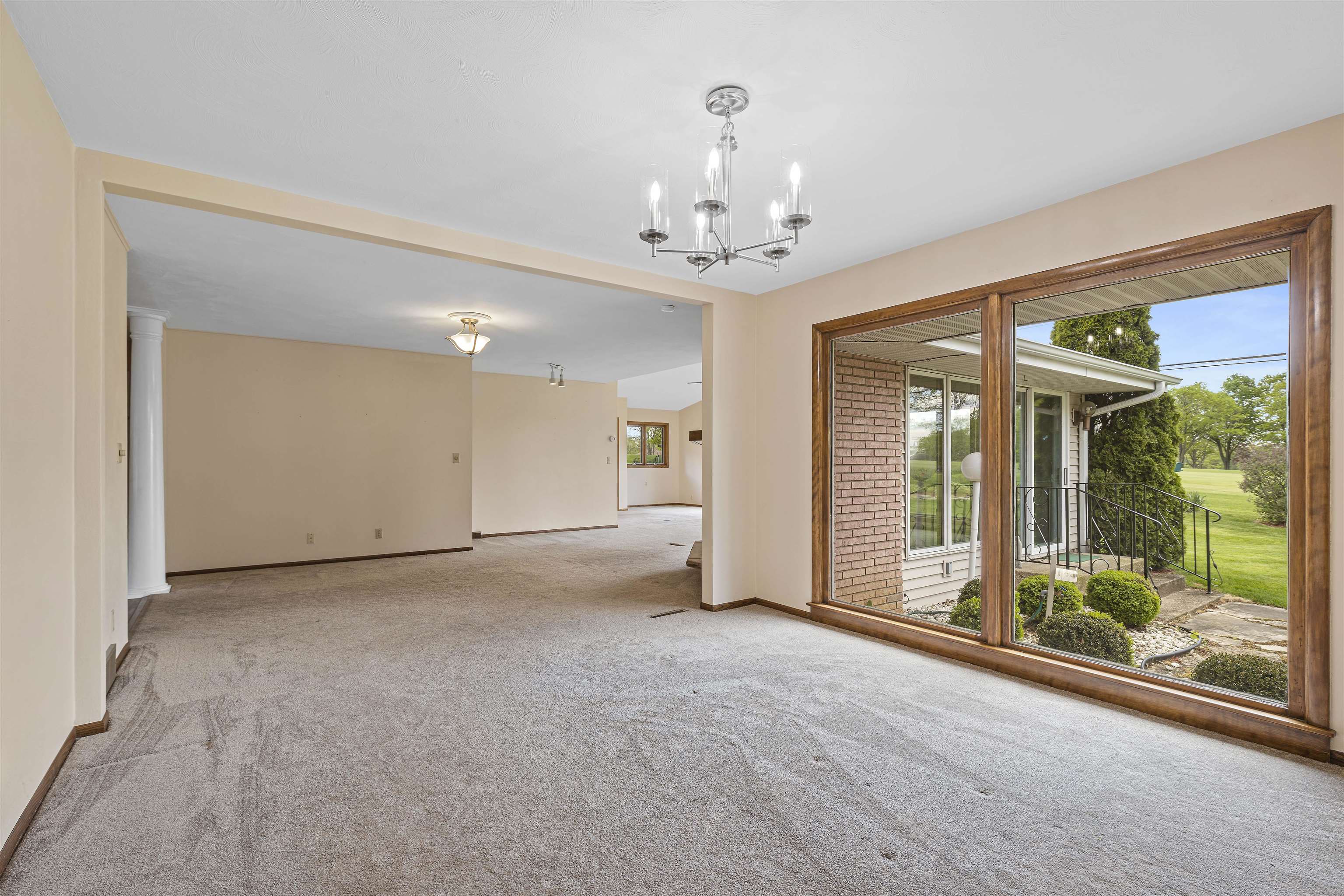 814 Roxbury Road Rockford, IL 61107 - Photo 10 of 36 a view of a big room with windows and chandelier
