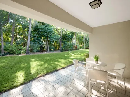 a view of a two chairs in backyard of the house