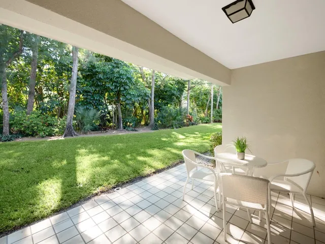 a view of a two chairs in backyard of the house