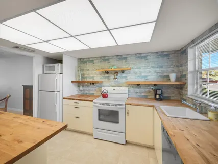 a kitchen with a stove sink and refrigerator