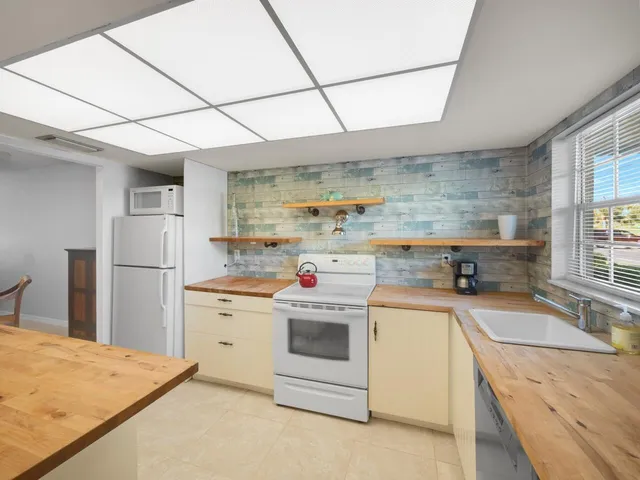 a kitchen with a stove sink and refrigerator