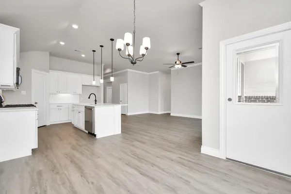 a view of a kitchen with cabinets and wooden floor