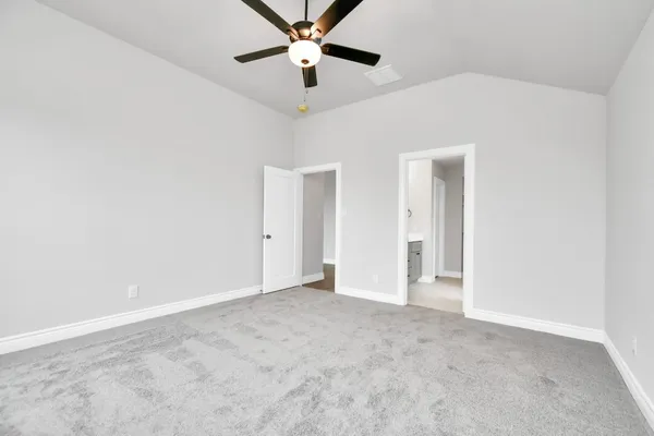 an empty room with chandelier fan