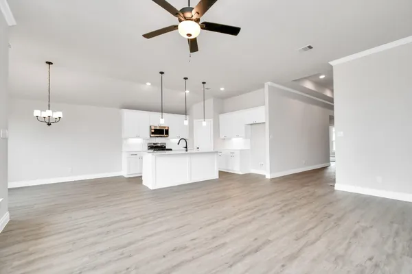 a view of kitchen with cabinets and wooden floor