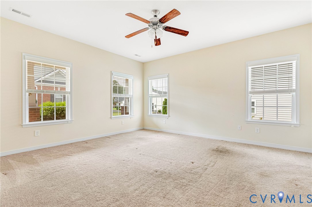 8996 Brigadier Road, Unit 4A Mechanicsville, VA 23116 - Photo 24 of 35 an empty room with windows and ceiling fan