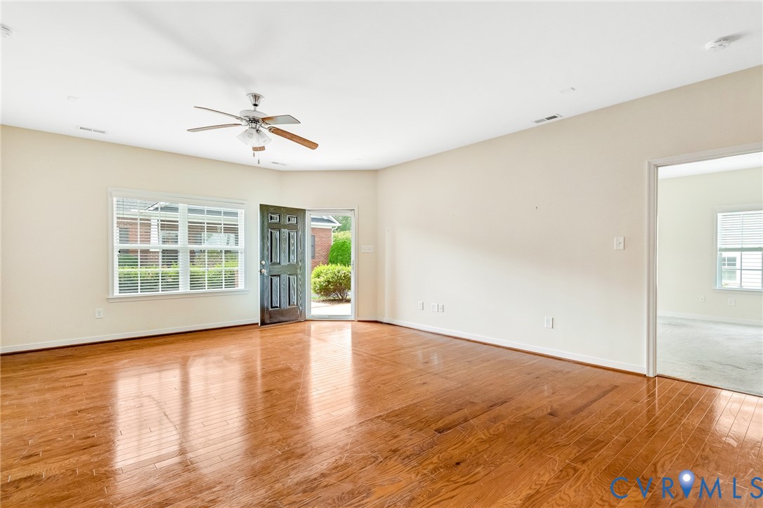 8996 Brigadier Road, Unit 4A Mechanicsville, VA 23116 - Photo 5 of 35 a view of an empty room with wooden floor and a window