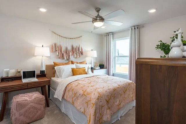 a bedroom with a large bed and a chandelier