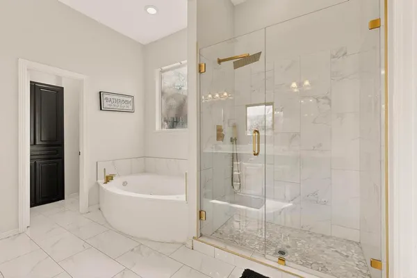 a bathroom with a bathtub and shower