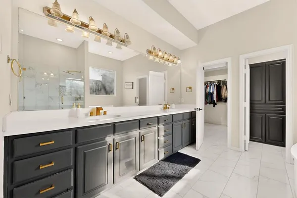 a large kitchen with a sink and cabinets