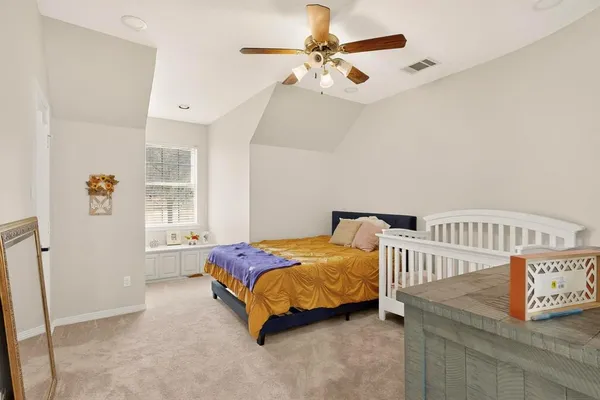 a bedroom with two beds and a chandelier
