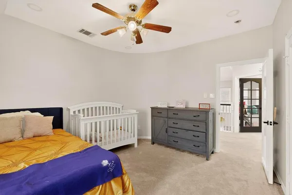 a bedroom with a bed and a chandelier