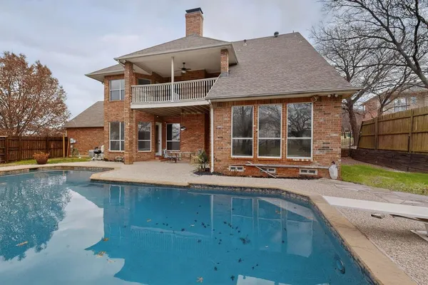 a view of a house with sitting area and swimming pool
