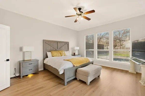 a bedroom with a large bed and a large window