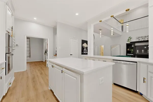 a view of a kitchen with cabinets and wooden floor