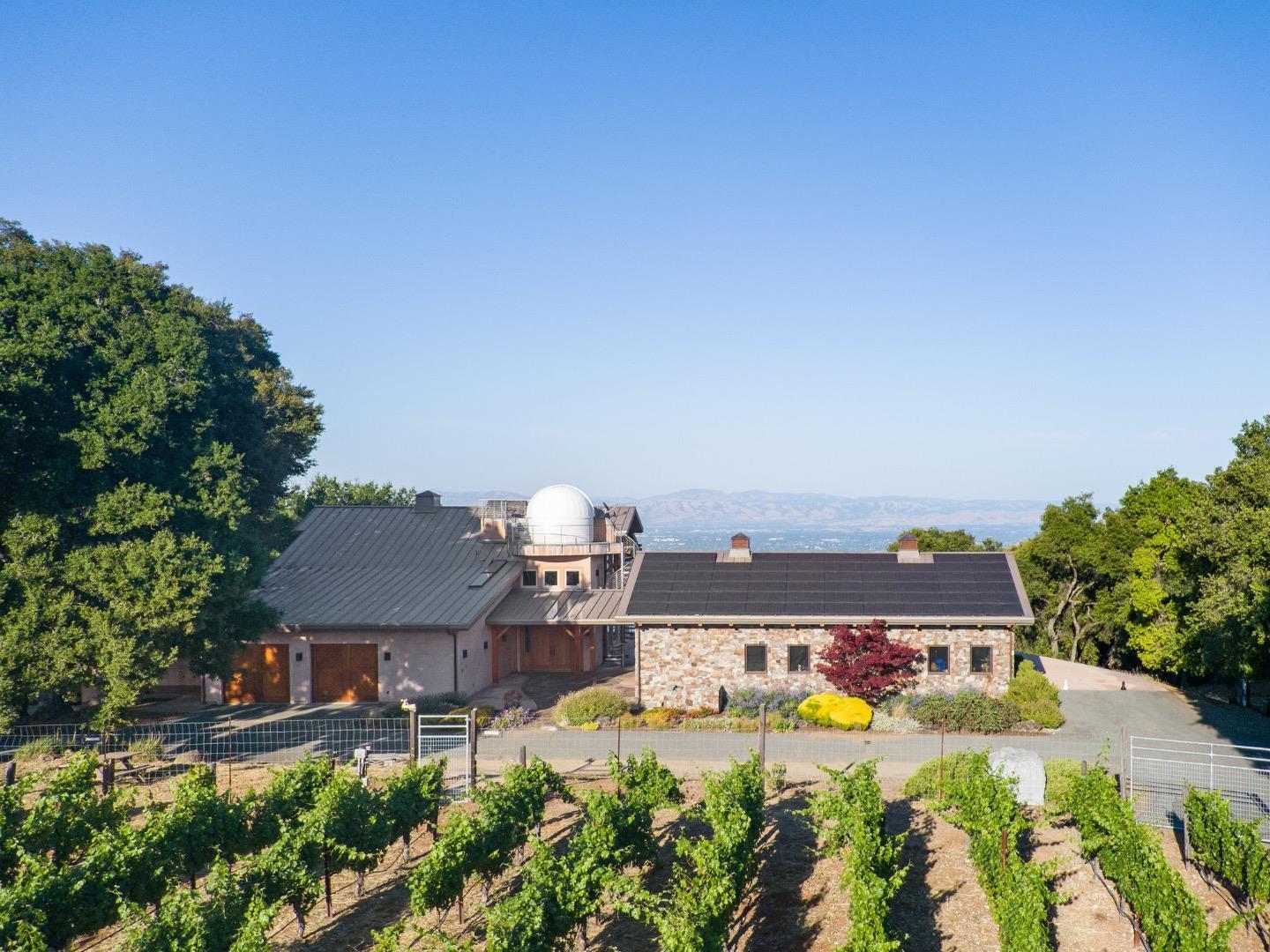 an aerial view of a house with a garden and lake view