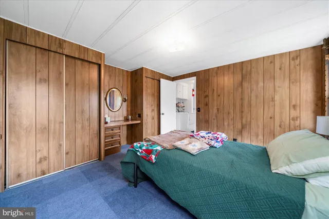 a bedroom with a bed and a closet