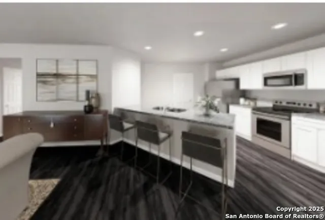 a kitchen with a sink appliances and cabinets